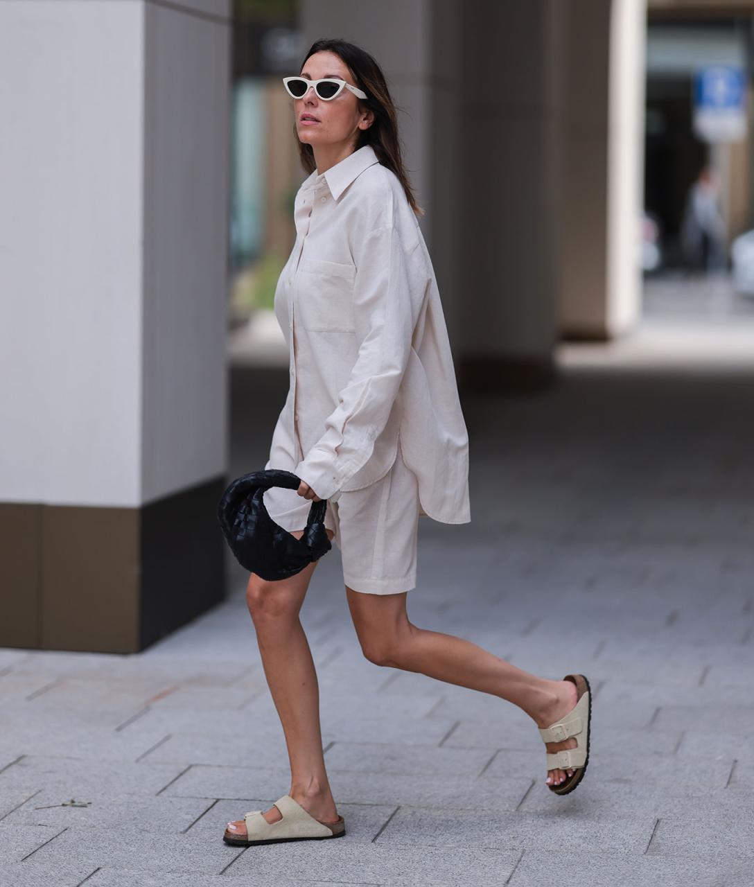 woman wearing a neutral top and shorts and birkenstocks