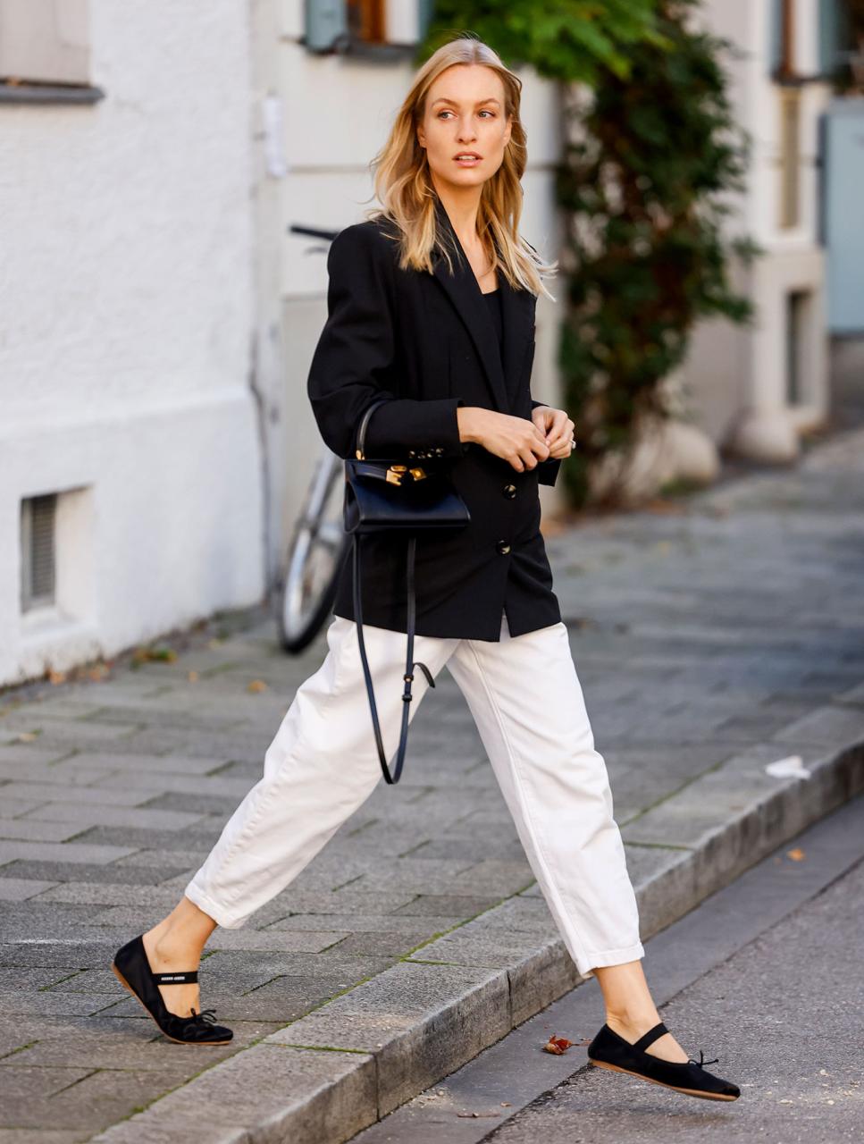 woman wearing white jeans and a black blazer