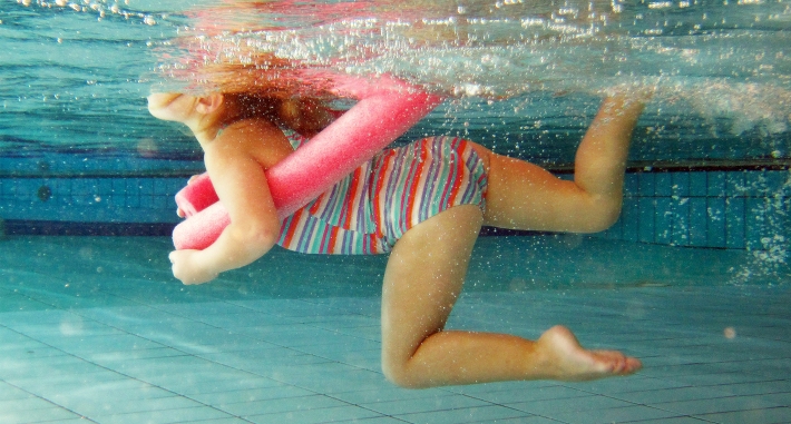 worswimsuit color for kids water safety: Young Girl Swimming at the Pool